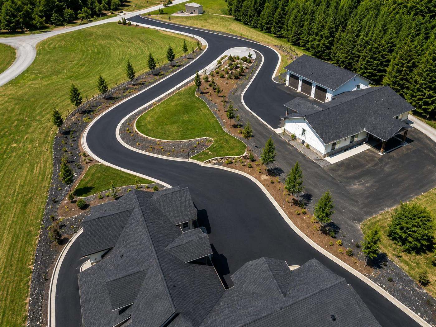 Aerial view of a freshly paved black asphalt driveway at a Hobbs NM home